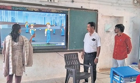 A teacher demonstrates how a digital class works at ZPHS Pedda Lingapur on Tuesday.