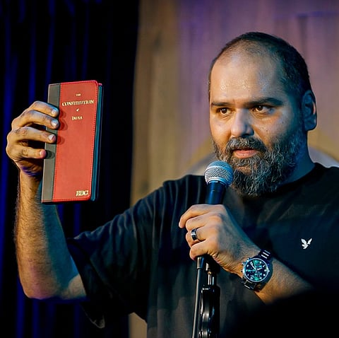 Kunal Kamra holding the Indian Constitution as a symbol of free speech