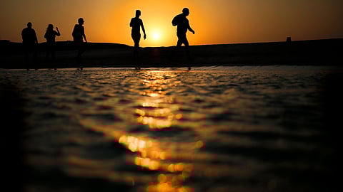 Tourists walk on the Giftun Island beach as the sun sets over the Red Sea in Hurghada, Egypt (Photo | AP)