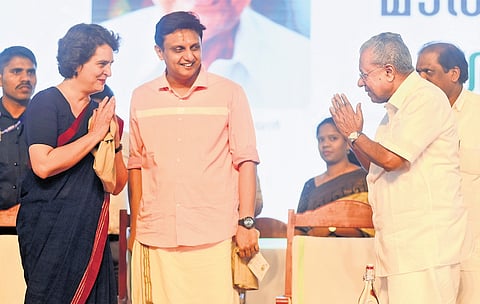 Chief Minister Pinarayi Vijayan greets Wayanad MP Priyanka Gandhi as he leaves the stage after laying the foundation stone of the Wayanad township project, in Kalpetta on Thursday. Public Works Minister Mohamed Riyas is also seen 