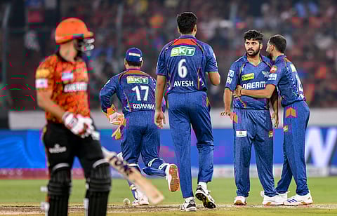 Lucknow Super Giants' Shardul Thakur celebrates with teammates after taking the wicket of Sunrisers Hyderabad's Abhinav Manohar.