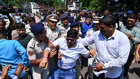  Congress MLA Pabitra Saunta taken into custody while protesting at assembly gate, against the suspension on 12 party MLAs, in Bhubaneswar on Wednesday.
