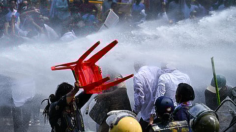 Water canons sprayed at congress workers during a protestors to gherao state assembly while demanding for House Committee formation to address growing crimes against women at Mahatma Gandhi Marg in Bhubaneswar on Thursday. 
