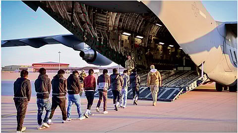 A batch of illegal immigrants from India boarding a US military plane in shackles.