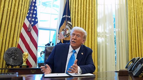 FILE - President Donald Trump speaks to reporters as he signs executive orders in the White House, Feb. 4, 2025, in Washington