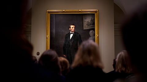 FILE - People gather for a ribbon cutting ceremony at the Smithsonian's National Portrait Gallery to announce the installation of a life-size painting of President Abraham Lincoln by artist W.F.K. Travers