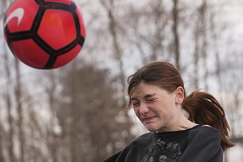 Parker Tirrell, a transgender athlete who plays on her high school's girls soccer team, heads the ball, Friday, March 7, 2025, in Plymouth, N.H.