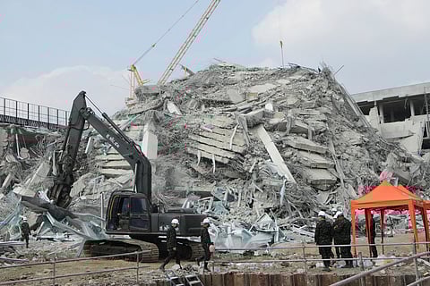Rescuers use a heavy duty machine to clear the rubble in Bangkok, Thailand, Saturday, March 29, 2025, as they search for victims at the site of a high-rise building under construction that collapsed after Friday's earthquake.