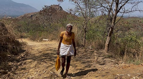 74-year-old Margabandu M slowly climbs the stony terrain of Neknamalai Hills in Tirupattur