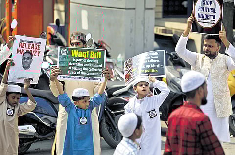 A group of Muslims hold placards against Wakf Board Amendment Bill by the central government after their prayer on the occasion of Eid Ul Fitr (Ramzan) at Mysore Road Eidgah Maidan in Bengaluru on Monday.