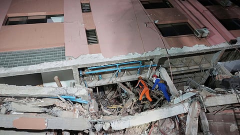 In this photo released by Xinhua News Agency, rescuers search for survivors at a collapsed building in the aftermath of an earthquake in Mandalay, Myanmar on Sunday, March 30, 2025.