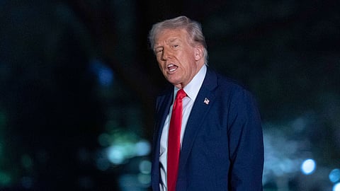 President Donald Trump talks to reporters as he walks on the South Lawn of the White House, in Washington, Sunday, March 30