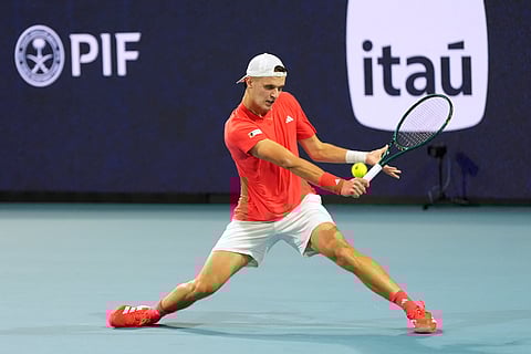Jakub Mensik, of Czech Repbulic, plays a shot to Novak Djokovic, of Serbia, in the men's singles final match at the Miami Open tennis tournament, Sunday, March 30, 2025, in Miami Gardens, Fla. 