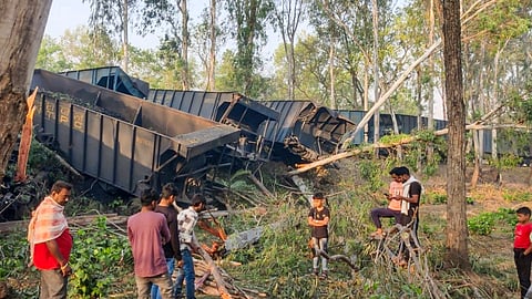  People near the damaged wagons after two goods trains collided in Sahibganj district of Jharkhand.