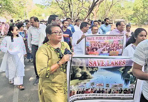 Students and teachers take out a protest rally over land auction issue at the University of Hyderabad on Wednesday