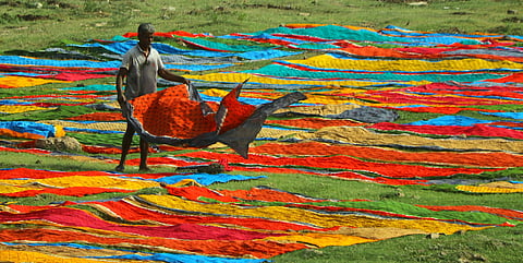 Making Sungudi involves tying thousands of small knots on a cotton sari — using thread and then dyeing the sari. 