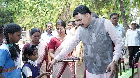 School and Mass Education minister Nityananda Gond  distributing laddoos.