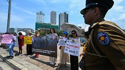 Sri Lankan animal rights activists take part in a demonstration in Colombo on April 3, 2025, to protest the round-up of stray dogs a day ahead of a visit by Prime Minister Narendra Modi. 