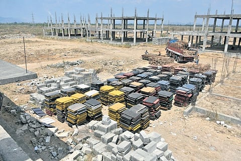 Building material is being unloaded at the construction site of judges houses as the works are about to begin in Amaravati on Thursday. 