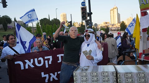 People protest against Prime Minister Benjamin Netanyahu's government as they block a highway in Jerusalem, Monday, March 31, 2025.