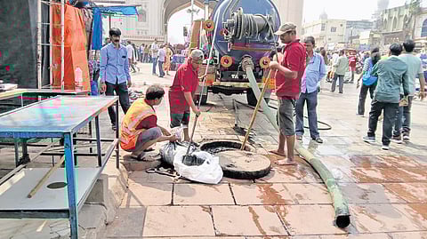 Hyderabad Metropolitan Water Supply and Sewerage Board staff carry out  desilting works as part of special drive in Charminar on Thursday