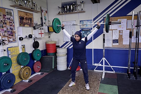 French weightlifting champion Sylvie Eberena trains in Mantes-la-Jolie wearing a hijab, on the outskirts of Paris, on March 26, 2025.