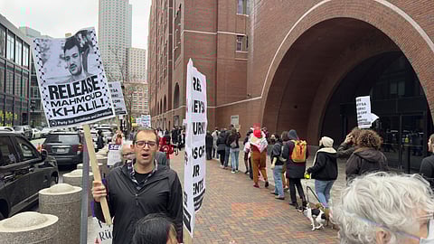 Protesters gather outside federal court during a hearing with lawyers for Rumeysa Ozturk, a Tufts University doctoral student from Turkey who was detained by immigration authorities, Thursday, April 3, 2025, in Boston.