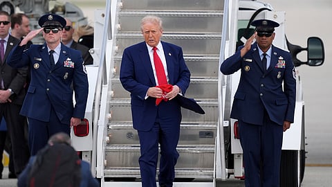 President Donald Trump, center, arrives on Air Force One at Miami International Airport, Thursday, April 3, 2025, in Miami.