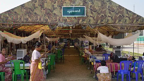 Patients are seen at a makeshift tent opened for medical care after last week's earthquake in Naypyitaw, Myanmar, Friday, April 4, 2025.