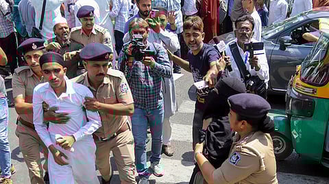 Police personnel detain people protesting the passage of the Waqf (Amendment) Bill in the Parliament, in Ahmedabad, Gujarat, Friday, April 4, 2025. 