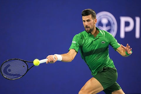 Novak Djokovic, of Serbia, plays a shot to Jakub Mensik, of Czech Republic, in the men's singles final match at the Miami Open tennis tournament, Sunday, March 30, 2025, in Miami Gardens, Fla. 