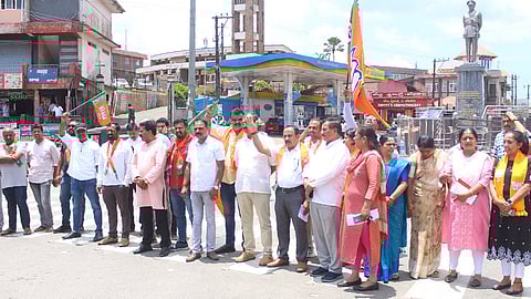 BJP workers are protesting on the road in Kodagu and demanding the arrest of the Congress spokesperson over the suicide abetment claim.