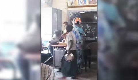 A screengrab of the video where Lakshmi is seen hitting the student with a broomstick