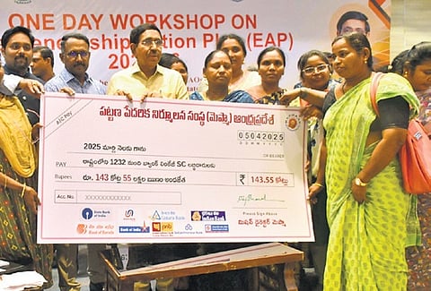 Minister P Narayana handovers cheque to beneficiaries during the one day workshop on entrepreneurship in Vijayawada on Saturday.