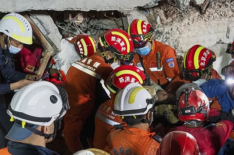 In this photo released by Xinhua News Agency, rescuers move a survivor out from a collapsed building in the aftermath of an earthquake in Mandalay, Myanmar, Monday, March 31, 2025. 