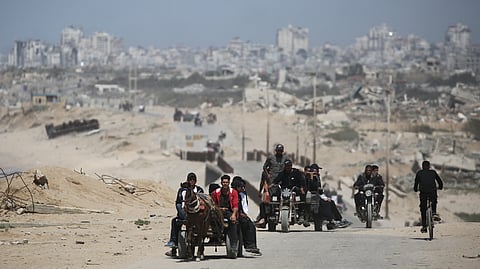 Palestinians ride vehicles along the coastal al-Rashid road.