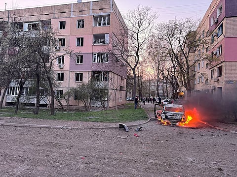 Burning car next to damaged buildings in Kryvyi Rig, Dnipropetrovsk region, after a reported missile strike amid the Russian invasion on Ukraine.
