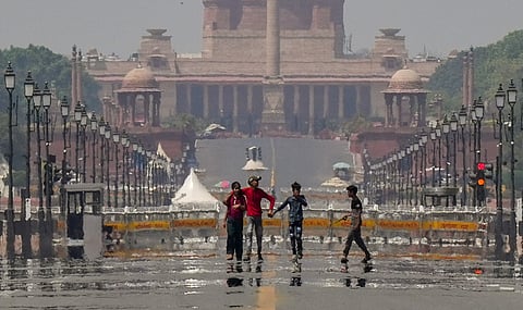 Visitors take a walk on Kartavya Path as a mirage appears on a hot summer day, in New Delhi, Sunday, April 6, 2025. 