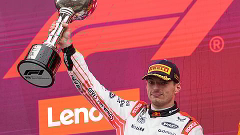 Red Bull driver Max Verstappen of the Netherlands celebrates with his trophy on the podium after the Japanese Formula One Grand Prix at the Suzuka Circuit in Suzuka.