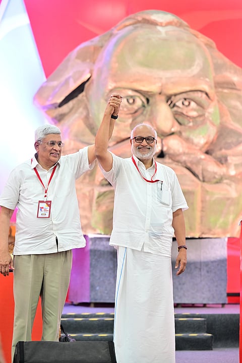 M A Baby, the newly elected general secretary of CPM, and politburo coordinator Prakash Karat raise hands during the 24th Party Congress in Madurai on Sunday.