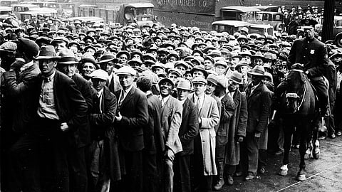 In this photo from Oct. 9, 1930, thousands of unemployed people gather outside City Hall in Cleveland during the Great Depression, after some 2,000 jobs were made available for park improvements and repairs.