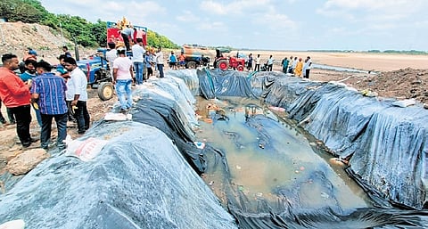 CMC staff filling the temporary pond with water from tankers on Tuesday.