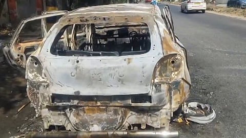 Charred remains of a car a day after it caught fire in the Bijwasan-Kapashera area of South West Delhi.