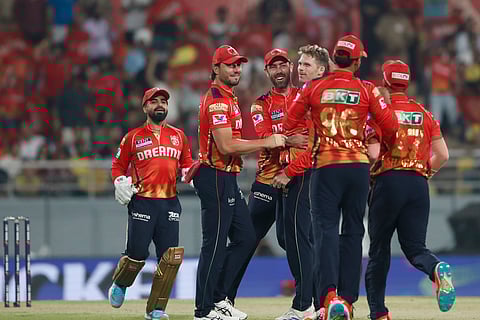 Punjab Kings' Lockie Ferguson, without cap, celebrates with teammates after the dismissal of Chennai Super Kings captain Ruturaj Gaikwad (Photo | AP)