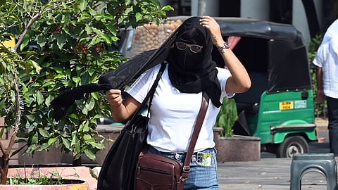 People brave the heat wave during a hot summer day, on April 8 2025 in New Delhi.
