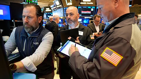 Traders work on the floor at the New York Stock Exchange in New York, Tuesday, April 8, 2025.