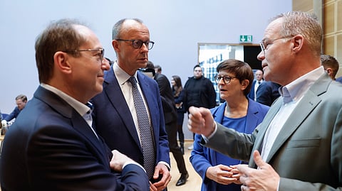 From left, Parliamentary Group Leader of the Bavarian conservative Christian Social Union (CSU) party Alexander Dobrindt, leader of Germany's Christian Democratic Union (CDU) Friedrich Merz and the co-leader of the Social Democratic Party (SPD) Saskia Esken prior to coalition talks between SPD CDU/CSU at the SPD headquarters in Berlin, Friday March 28, 2025.