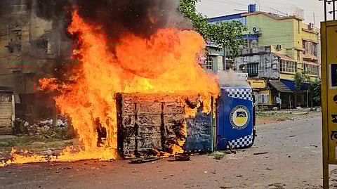 Smoke and flames billow out from a vehicle after it was set ablaze during a protest over the Waqf (Amendment) Act, in Murshidabad district of West Bengal, Tuesday, April 8, 2025.