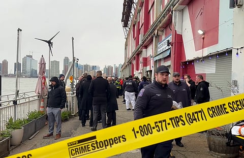 First responders walk along Pier 40, Thursday, April 10, 2025, in New York, across from where a helicopter went down in the Hudson River in Jersey City, N.J. 