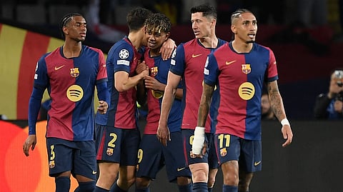 Barcelona's Spanish forward #19 Lamine Yamal (C) celebrates with teammates scoring his team's fourth goal during the UEFA Champions League Quarter final First Leg football match between FC Barcelona and BVB Borussia Dortmund at the Estadi Olimpic Lluis Companys in Barcelona on April 9, 2025.